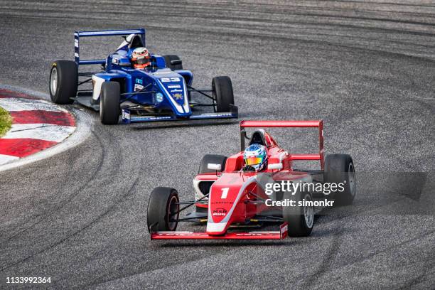 men driving formula racing cars - motorsport grand prix stock pictures, royalty-free photos & images