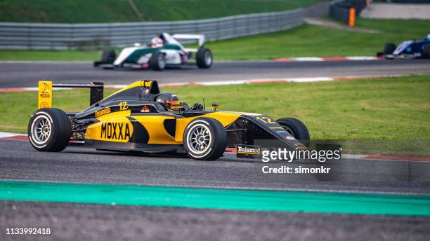 man driving formula racing car - athletics grand prix stock pictures, royalty-free photos & images