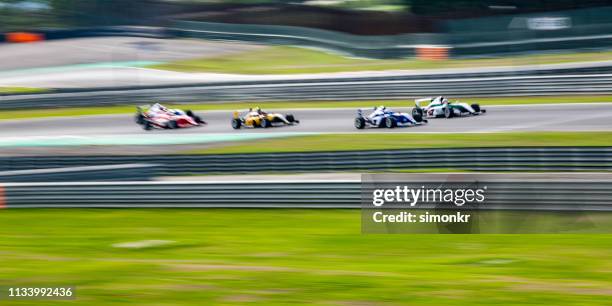 men driving formula racing cars - athletics grand prix stock pictures, royalty-free photos & images