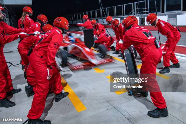 racing team working at pit stop - pit stop stock pictures, royalty-free photos & images