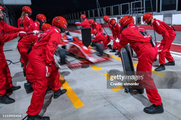 racing team working at pit stop - pit crew challenge stock pictures, royalty-free photos & images