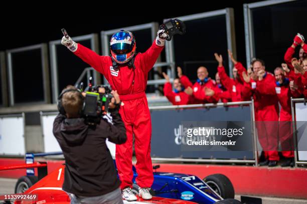 cameraman interviewing formula driver - car racing stock pictures, royalty-free photos & images