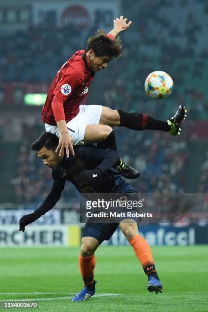 Kazuki Nagasawa of Urawa Red Diamonds competes for the ball against Supachok Sarachart of Buriram United during the AFC Champions League Group G...