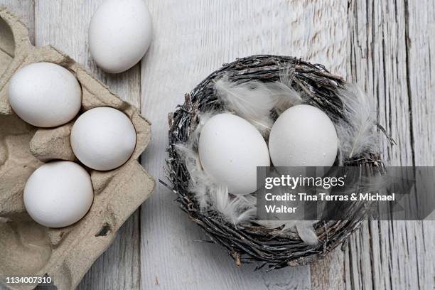 egg in nest on dark wooden background. easter. - osterei stock pictures, royalty-free photos & images