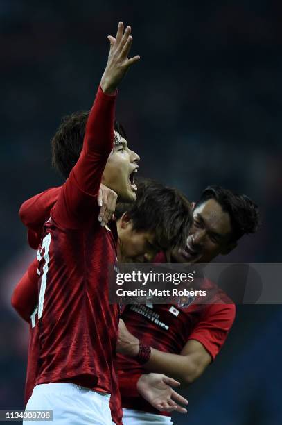 Daiki Hashioka of Urawa Red Diamonds celebrates scoring a goal with Koya Yuruki and Tomoaki Makino during the AFC Champions League Group G match...