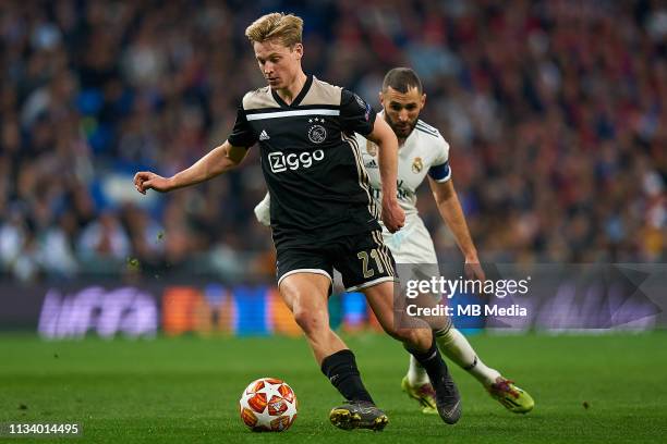 Frenkie de Jong of Ajax competes for the ball with Karim Benzema of Real Madrid CF during the UEFA Champions League Round of 16 Second Leg match...