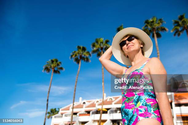 senior woman enjoying tropical holidays - playa de las americas stock pictures, royalty-free photos & images