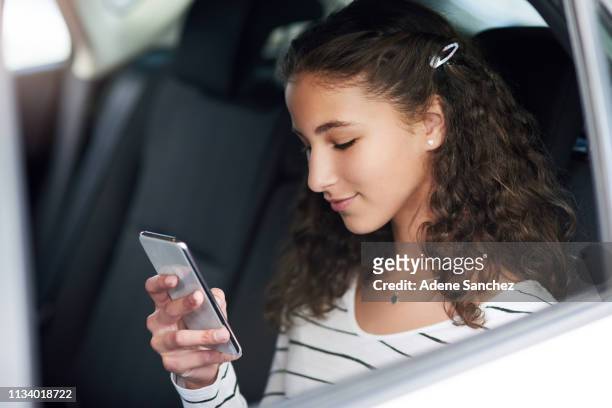 wireless technology keeps her connected with her friends - girl in car with ipad stock pictures, royalty-free photos & images
