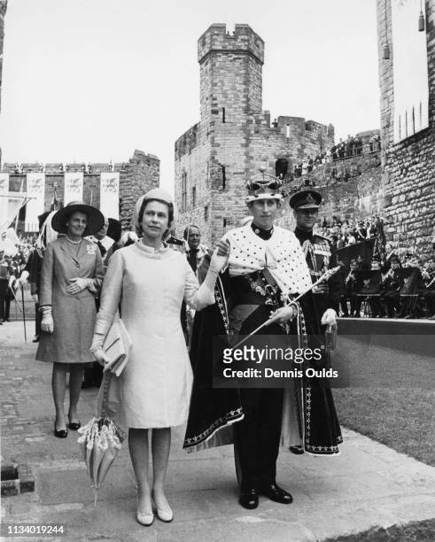 Prince Charles with Queen Elizabeth and Prince Philip, Duke of Edinburgh during the ceremony of Charles' Investment as Prince of Wales at Caernarfon...