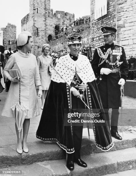 Prince Charles with Queen Elizabeth and Prince Philip, Duke of Edinburgh during the ceremony of Charles' Investment as Prince of Wales at Caernarfon...