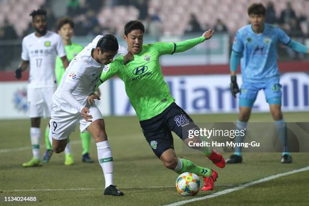 Yuning Zhang of Beijing Guoan competes for the ball with Hong Jeong-Ho of Jeonbuk Hyundai Motors during the AFC Champions League Group G match...