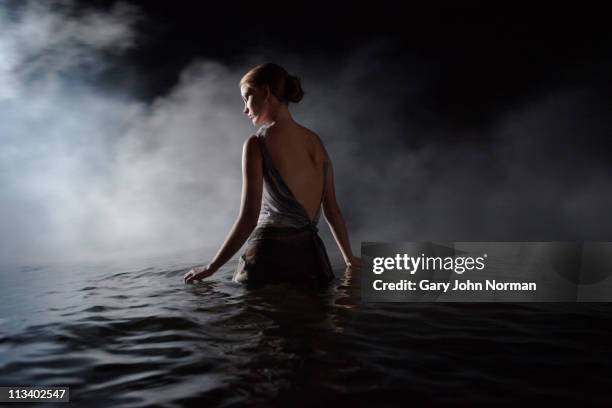 women in dress appears through smoke - wade bildbanksfoton och bilder