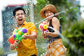 Asian people are using water guns play in the Songkran festival