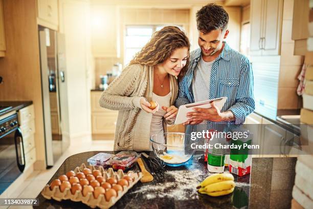 here's your next instruction - young couple cooking stock pictures, royalty-free photos & images