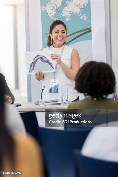 businesswoman uses chart during conference - world expo continues stock pictures, royalty-free photos & images