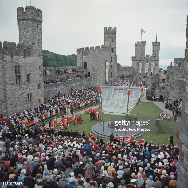 Spectators at Caernarfon Castle during the ceremony of investiture of Prince Charles as Prince of Wales, Gwynedd, Wales, 1st July 1969. At centre is...