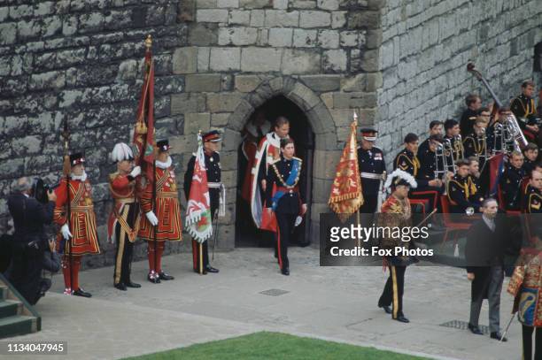 Prince Charles and his cortège emerge from the Chamberlain Tower, before his investiture as Prince of Wales at Caernarfon Castle, Gwynedd, Wales, 1st...