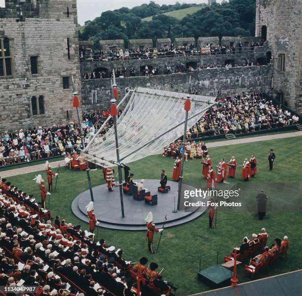 Prince Charles kneels before the Queen during the ceremony of his investiture as Prince of Wales at Caernarfon Castle, Gwynedd, Wales, 1st July 1969....