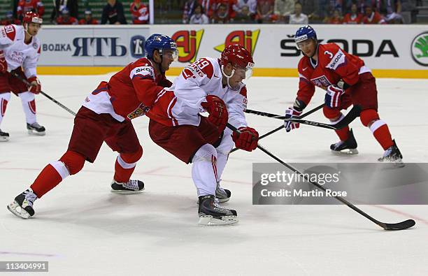 Roman Cervenka of Czech Republic and Mikkel Bodker of Denmark battle for the puck during the IIHF World Championship group D match between Czech...