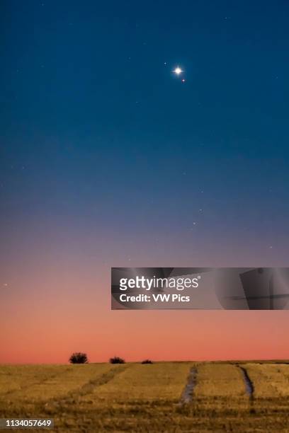 Venus and Mars in close conjunction in the dawn sky on October 5, 2017 Venus is the brightest object; Mars is below it; while the star above Venus is...