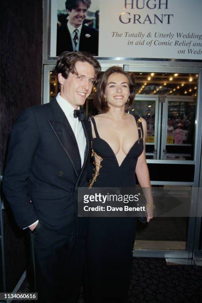 British actor Hugh Grant and his girlfriend Elizabeth Hurley arrive at the post-premiere party of Grant's latest film, 'Four Weddings and a Funeral'...