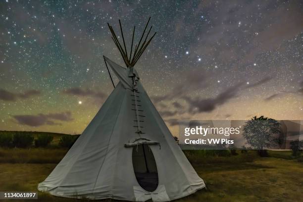 The Big Dipper and Arcturus at left over a single tipi at the Two Trees site at Grasslands National Park, Saskatchewan, August 6, 2018 This is a...
