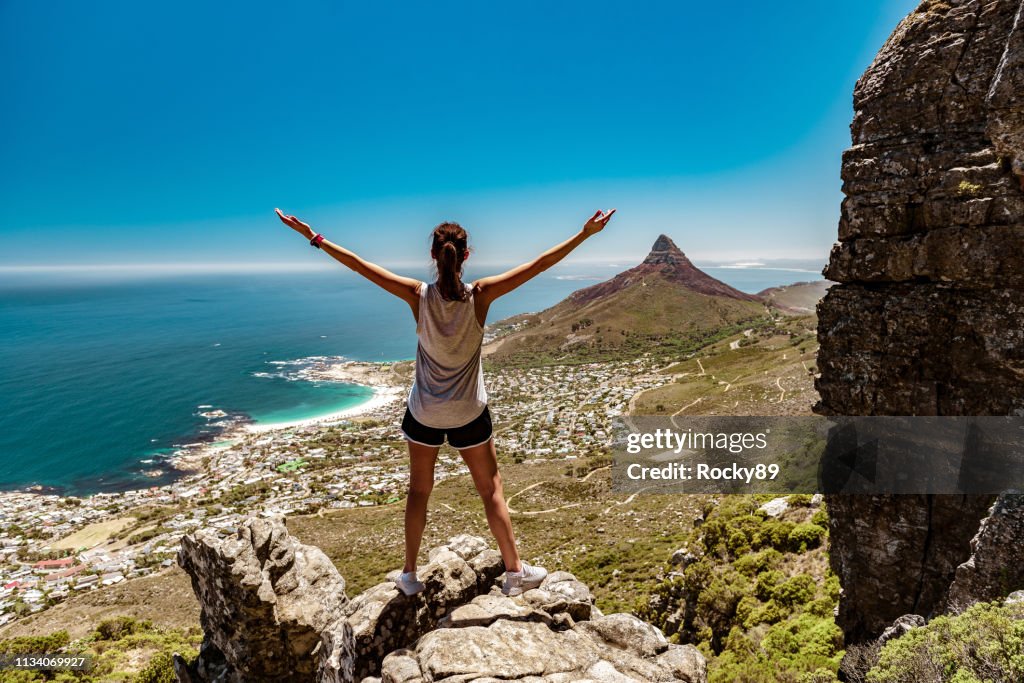 Tourist woman hiking Table Mountain looking at Lion's Head, Cape Town, South Africa