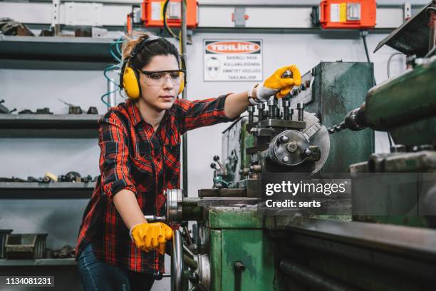 young lathe worker woman working with milling machine in factory - workplace danger stock pictures, royalty-free photos & images