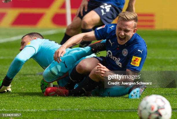 Hauke Wahl of Kiel crashes into his goalkeeper Kenneth Kronholm during the Second Bundesliga match between 1. FC Koeln and Holstein Kiel at...