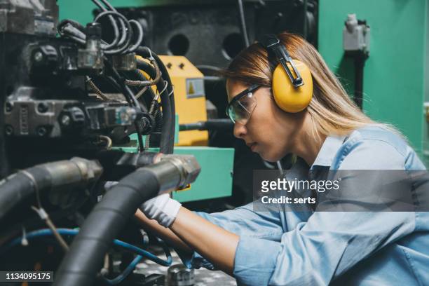 專業技術工人婦女, 從事生產線機械的工作 - ear protection 個照片及圖片檔