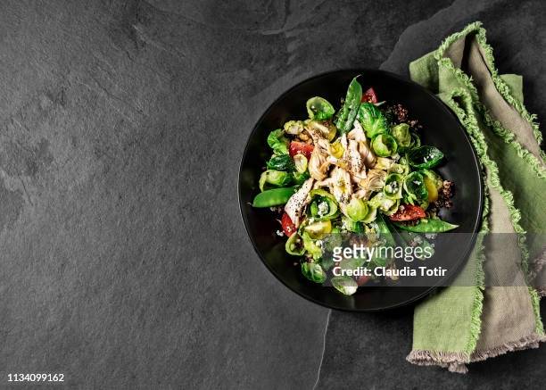 fresh salad with chicken breast on black background - salad bowl stock pictures, royalty-free photos & images