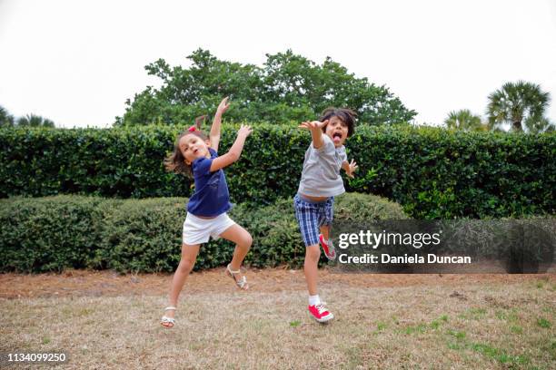 boy and girl dancing carefree - children dancing outside stockfoto's en -beelden