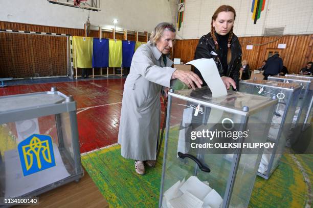 Woman casts her ballot paper at a polling station at the Azov Sea port of Mariupol during the first round of Ukraine's presidential election, on...