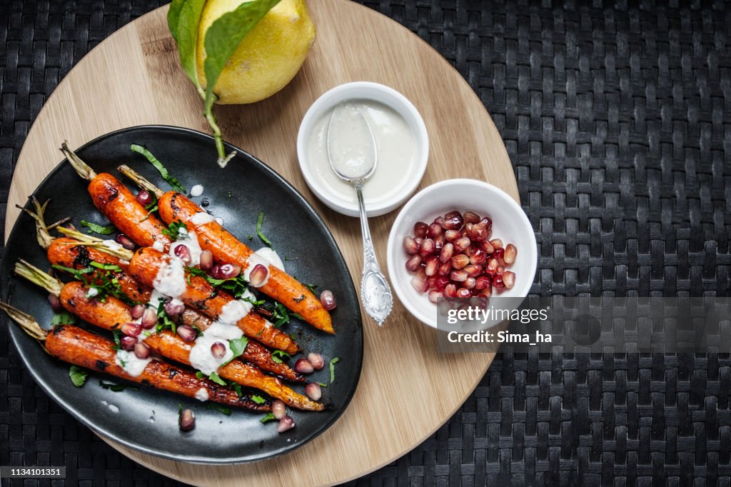 Sweet roasted carrots with tahini sauce, pomegranate