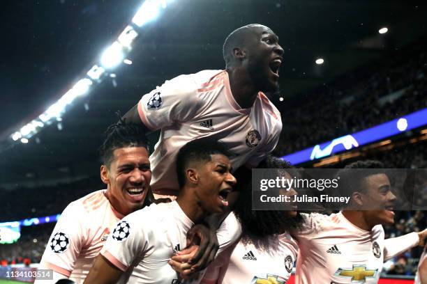 Marcus Rashford of Manchester United celebrates after scoring his sides third goal with teammates during the UEFA Champions League Round of 16 Second...