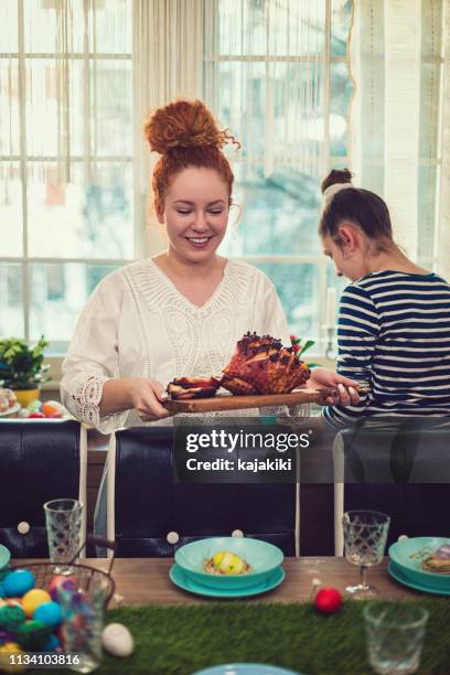 family preparing dining table for easter - roasted stock pictures, royalty-free photos & images