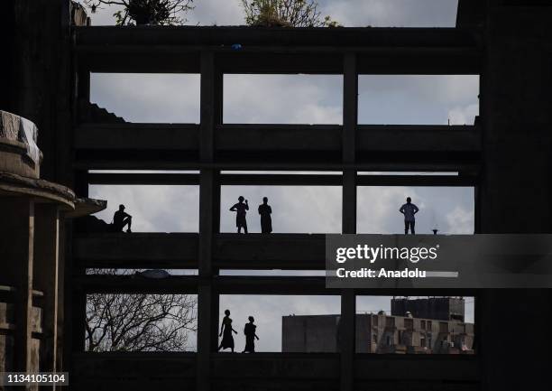 Mozambiqueans are seen at desolated buildings following the Cyclone Idai in Sofala region in Beira, Mozambique on March 31, 2019. Cyclone Idai made...