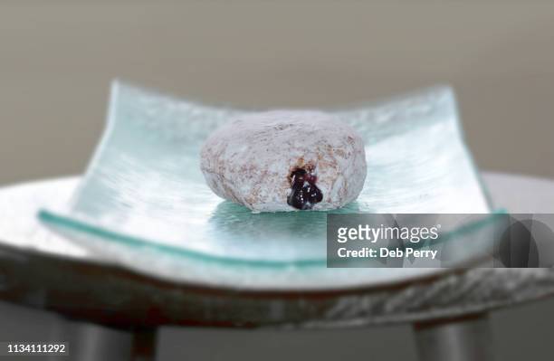 close up photo of a pączki (paczki) pastry on a teal platter - paczki stock pictures, royalty-free photos & images