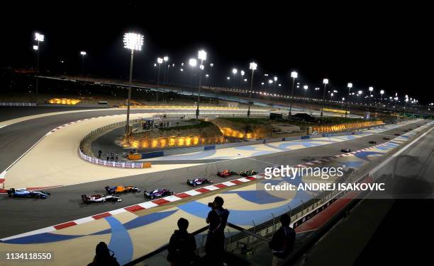 Drivers steer their cars during the Formula One Bahrain Grand Prix at the Sakhir circuit in the desert south of the Bahraini capital Manama, on March...