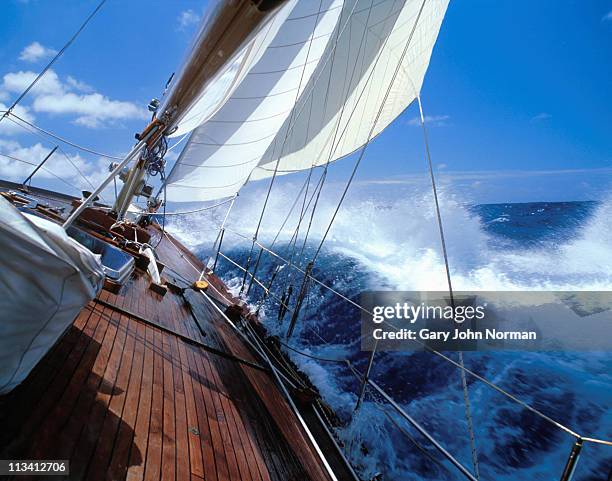 rolling deck of yacht crashing through waves - sailing competition stock pictures, royalty-free photos & images