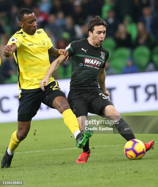 Mauricio Pereyra of FC Krasnodar vies for the ball with Gael Ondoua of FC Anzhi Makhachkala during the Russian Premier League match between FC...