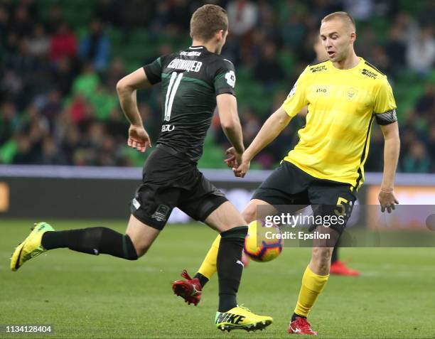 Dmitri Skopintsev of FC Krasnodar vies for the ball with Vladislav Kulik of FC Anzhi Makhachkala during the Russian Premier League match between FC...