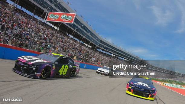 Jimmie Johnson, driver of the Ally Chevrolet, leads the field at the start of the Monster Energy NASCAR Cup Series O'Reilly Auto Parts 500 at Texas...