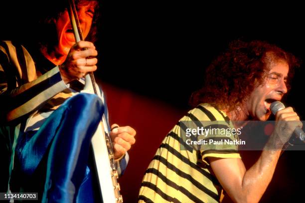 German Rock musicians Matthias Jabs , on guitar, and vocalist Klaus Meine, both of the group of the Scorpions, perform onstage at the Aragon...