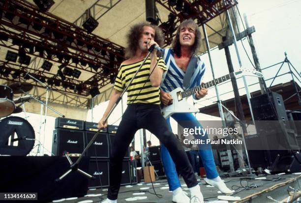 German Rock musicians vocalist Klaus Meine and Matthias Jabs, on guitar, both of the group Scorpions, perform onstage at the Rockford Speedway,...