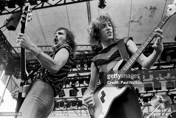 German Rock musicians Rudolph Schenker , on guitar, and Francis Buchholz, on bass guitar, both of the group Scorpions, perform onstage at the...