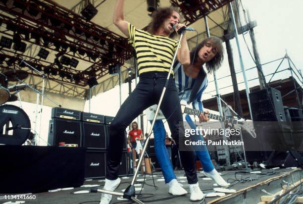 German Rock musicians vocalist Klaus Meine and Matthias Jabs, on guitar, both of the group Scorpions, perform onstage at the Rockford Speedway,...