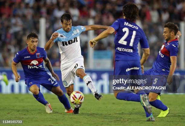 Racing Club's forward Dario Cvitanich controls the ball pressured by Tigre's midfielder Sebastian Prediger , defender Lucas Rodriguez and midfielder...