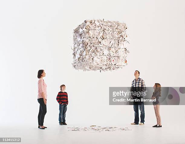family looking at floating paper bale - mother on white background stock pictures, royalty-free photos & images