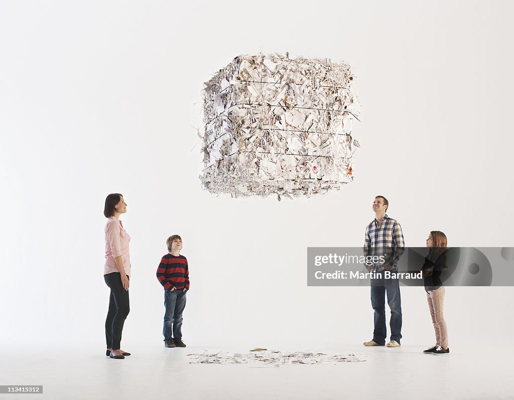 Family looking at floating paper bale